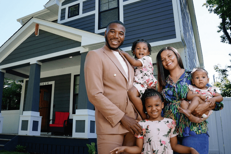 Family standing outside their home
